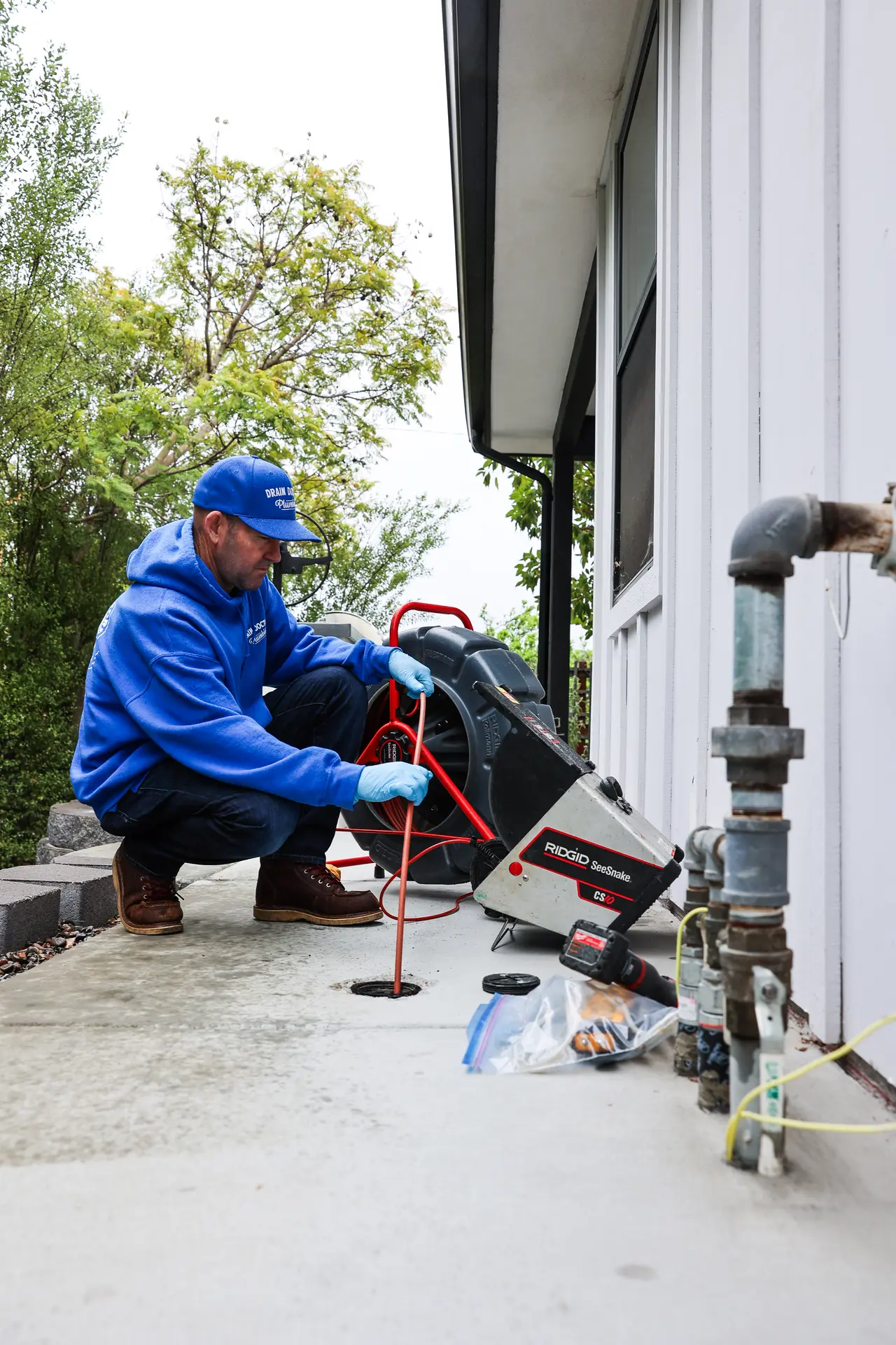 Drain Doctors Plumbing technician running a sewer camera inspection