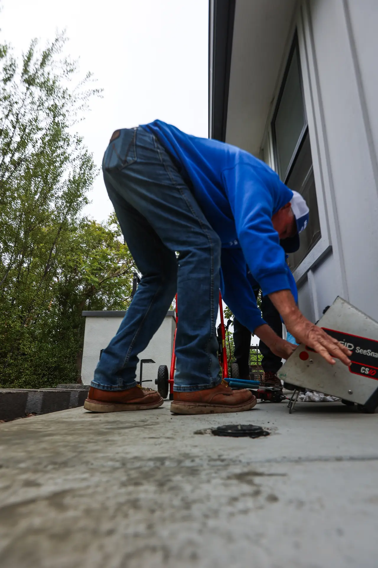 Drain Doctors Plumbing technician running a sewer camera inspection before drain cleaning