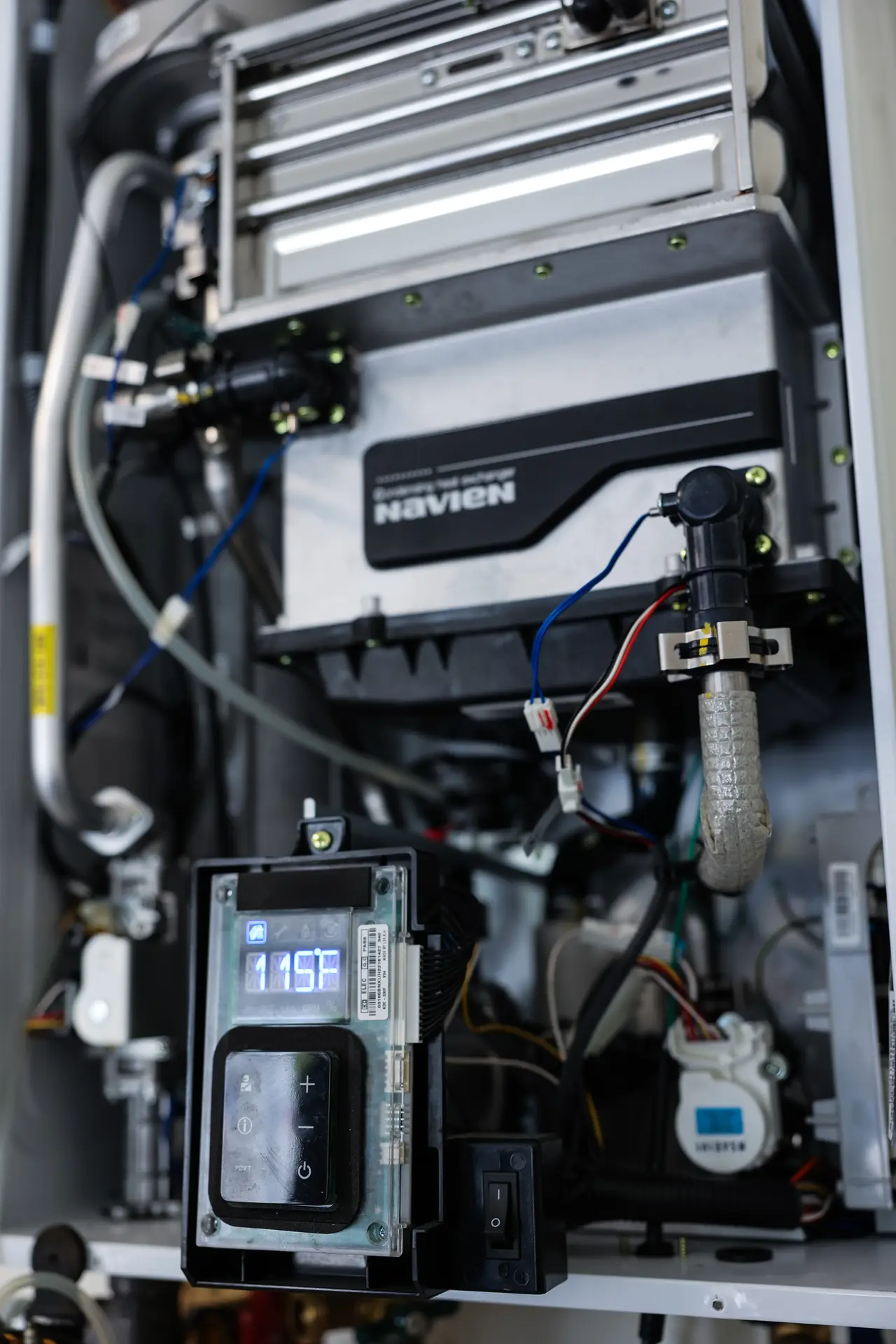 Close-up of a wall-mounted tankless water heater in a Central Coast home