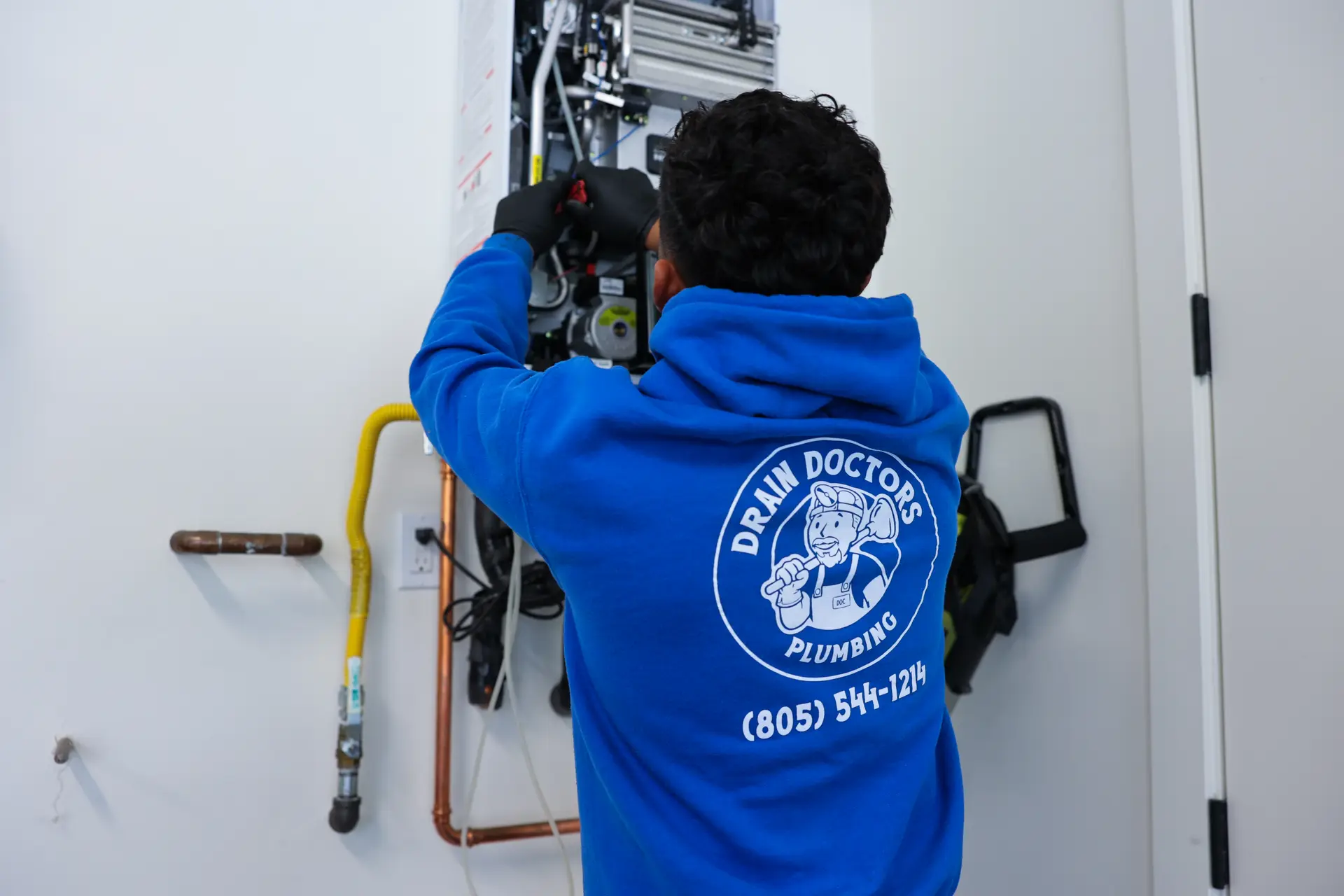 Technician servicing a tankless water heater