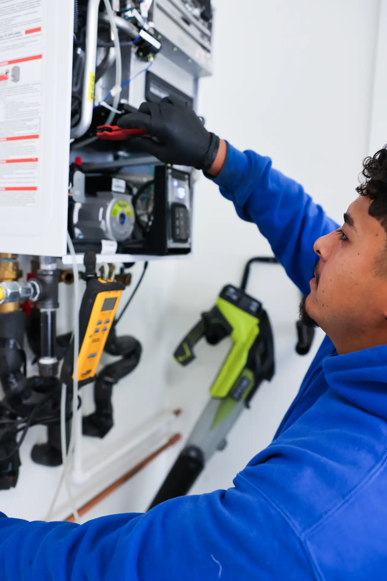 Drain Doctors Plumbing technician servicing a tankless water heater