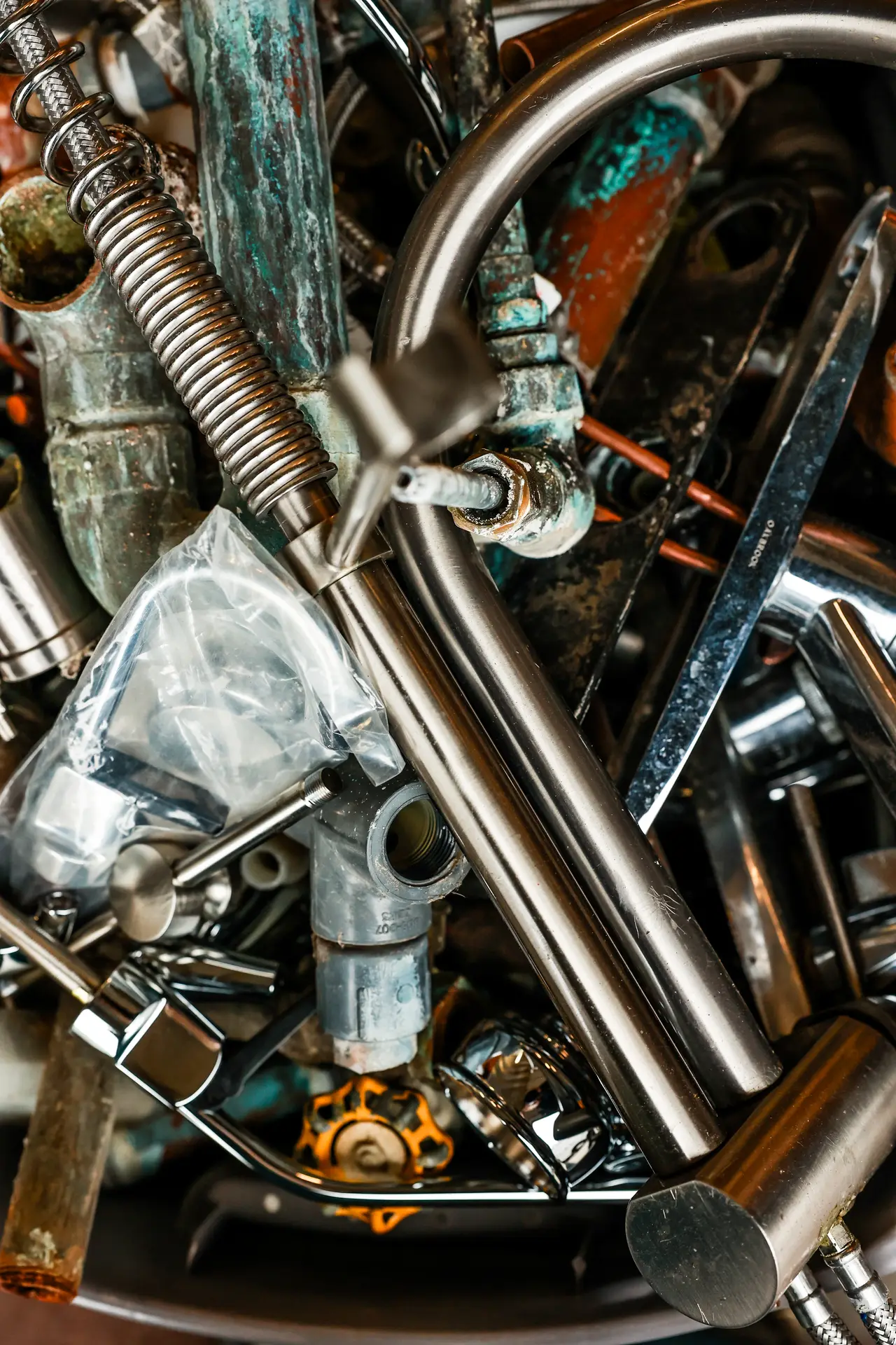 Close-up of plumbing pipe fittings and parts at the Drain Doctors Plumbing shop