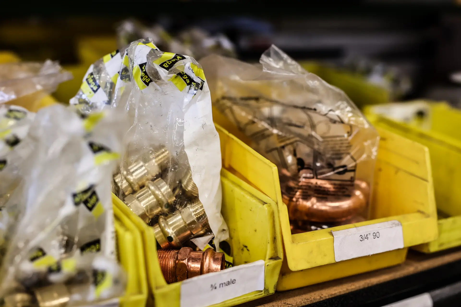 Copper pipe fittings stocked on shelves in the Drain Doctors Plumbing warehouse