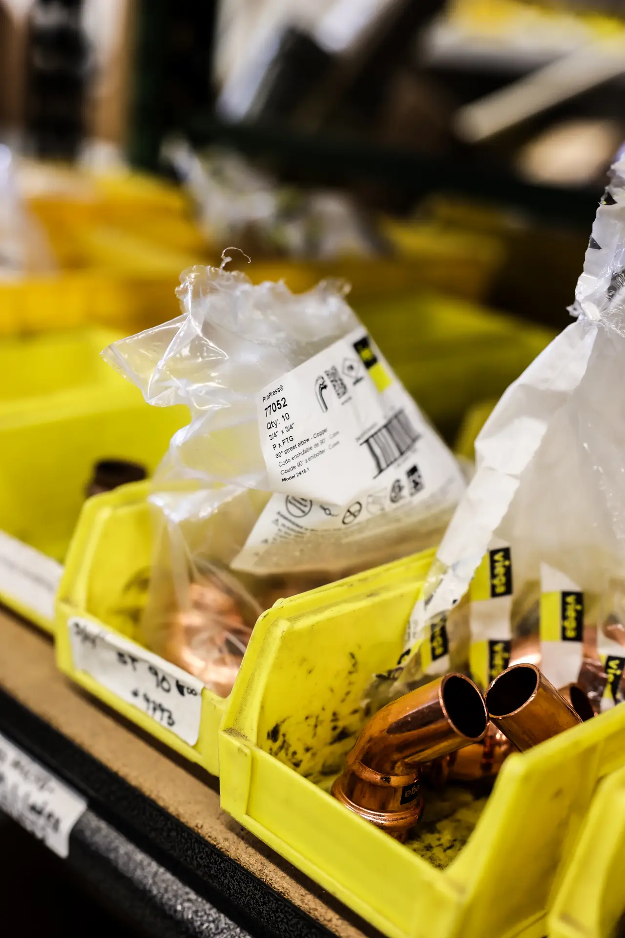 Copper pipe fittings stocked on shelves in the Drain Doctors Plumbing warehouse
